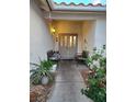 Charming entryway featuring double doors, decorative benches, and colorful plants at 6435 Heatherton Ave, Las Vegas, NV 89110