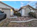 Single-story home boasting a two-car garage, inviting front yard, and charming curb appeal at 6435 Heatherton Ave, Las Vegas, NV 89110