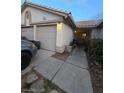 Charming home with a well-lit exterior, two car garage, and desert landscaping at 6435 Heatherton Ave, Las Vegas, NV 89110