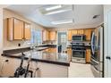 Well-equipped kitchen featuring stainless steel appliances and a breakfast bar at 7705 Granberg Ct, Las Vegas, NV 89131