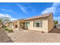 Low-maintenance backyard featuring a covered patio and desert landscaping, perfect for outdoor living at 7824 Homing Pigeon St, North Las Vegas, NV 89084