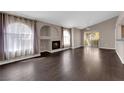 Spacious living room with fireplace, dark wood floors, archway architectural detail and lots of natural light at 7950 W Flamingo Rd # 2019, Las Vegas, NV 89147
