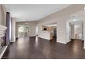 Open floor plan featuring living room with dark floors adjoining kitchen and balcony, ideal for entertaining at 7950 W Flamingo Rd # 2019, Las Vegas, NV 89147