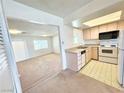 Open concept kitchen featuring basic appliances and a view to the living room at 810 E Calvada Blvd, Pahrump, NV 89048