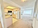 Cozy kitchen featuring basic appliances and an open layout to the living area at 810 E Calvada Blvd, Pahrump, NV 89048
