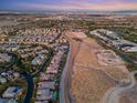 Community aerial view showcasing neighborhood layout and home proximity to city skyline at 82 Glade Hollow Dr, Las Vegas, NV 89135