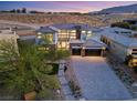 Aerial view of a modern home showcasing stone accents and a paved driveway at 82 Glade Hollow Dr, Las Vegas, NV 89135