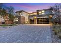 Stunning facade with modern garage door, neutral tones, and meticulously paved driveway at 82 Glade Hollow Dr, Las Vegas, NV 89135