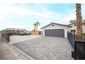 A paved driveway leads up to a two car garage at 8610 Mohawk St, Las Vegas, NV 89139