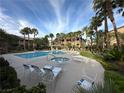 Resort-style pool area with lounge chairs, palm trees, and a relaxing atmosphere at 8985 S Durango Dr # 1033, Las Vegas, NV 89113