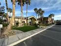 Community clubhouse with palm trees, grass, and paved parking at 8985 S Durango Dr # 1034, Las Vegas, NV 89113