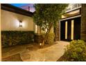 Inviting front entrance with stone walkway, lush landscaping, and modern front door at 921 Granger Farm Way, Las Vegas, NV 89145