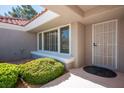 Inviting front entrance showcasing a security door, garden window, and manicured landscaping at 9524 Quail Ridge Dr, Las Vegas, NV 89134