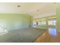 Bright living room with light green walls and a large window offering lots of natural light at 9524 Quail Ridge Dr, Las Vegas, NV 89134