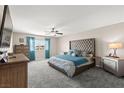 Spacious main bedroom with a king bed, ceiling fan, and plenty of natural light at 9588 Vital Crest St, Las Vegas, NV 89123