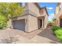 Close up of a home with a paver driveway and an attached two-car garage at 9636 Salford Isle St, Las Vegas, NV 89123
