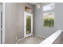 Welcoming entryway featuring tile floors, a decorative glass door, and ample natural light from clerestory and standard windows at 1709 Pacific Panorama Pl, Las Vegas, NV 89144