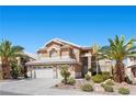 Two-story home with a two-car garage and desert landscaping at 283 Grand Olympia Dr, Henderson, NV 89012