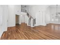 Spacious foyer with staircase, wood floors, soaring ceilings and decorative columns creating an inviting entrance at 283 Grand Olympia Dr, Henderson, NV 89012