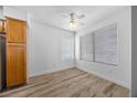 Light-filled bedroom with hardwood floors, ceiling fan and large windows at 3425 E Russell Rd # 155, Las Vegas, NV 89120
