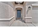 Inviting entryway with a stylish front door, decorative sign, and textured walls at 456 Desoto Falls St, Indian Springs, NV 89018