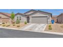Charming single-story home with desert landscaping and a two-car garage at 456 Desoto Falls St, Indian Springs, NV 89018