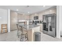Modern kitchen with stainless steel appliances, granite counters, and an island with seating at 456 Desoto Falls St, Indian Springs, NV 89018