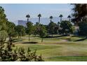 Picturesque golf course view featuring lush green fairways, mature trees, and distant mountain scenery at 4916 Mount Pleasant Ln, Las Vegas, NV 89113
