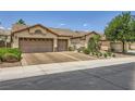 Beautiful single-story house with a two-car garage, tiled roof, and well-kept landscaping at 521 Dawn Cove Dr, Henderson, NV 89052