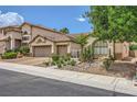Attractive single-story home with a manicured front yard, two-car garage, and tiled roof at 521 Dawn Cove Dr, Henderson, NV 89052