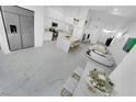 Spacious living room with modern decor, marble floors, and stainless steel refrigerator at 9155 Bush Poppy Ave, Las Vegas, NV 89147