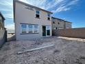 Backyard with sliding glass door, unfinished yard, and block wall at 9556 Hinson St, Las Vegas, NV 89139
