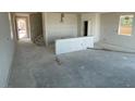 Spacious open-concept living area with a staircase and rough-in for kitchen buildout at 9556 Hinson St, Las Vegas, NV 89139