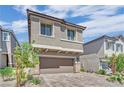 Charming two-story home featuring a paver driveway, attached two car garage and neutral exterior at 10038 W Meranto Ave, Las Vegas, NV 89178