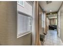 Hallway with tile flooring, modern decor, and open access to the living area at 10042 Bismuth St, Las Vegas, NV 89183