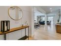 Inviting entryway features modern console table, round mirror and open floor plan at 1223 Starstone Ct, Henderson, NV 89014