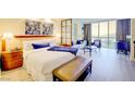 Comfortable bedroom featuring a plush king bed, cozy sitting area, and a large window with scenic city vistas at 135 E Harmon Ave # 804, Las Vegas, NV 89109