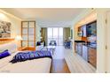 Stylish bedroom featuring a luxurious king bed, a convenient kitchenette, and a gorgeous city view from a large window at 135 E Harmon Ave # 804, Las Vegas, NV 89109
