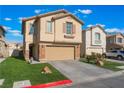 Tan two-story home with a two-car garage, stone accents, and a well-manicured lawn on a sunny day at 1618 Meno Peak St, Las Vegas, NV 89115