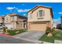 A tan two-story home with stone accents on the garage and porch with manicured front lawn at 1618 Meno Peak St, Las Vegas, NV 89115