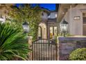 Inviting front entry featuring a gated courtyard with stone accents and a glimpse of interior elegance at 1994 Orchard Mist St, Las Vegas, NV 89135