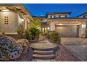 Elegant property showcasing a stone walkway with manicured shrubs and a charming courtyard entrance at 1994 Orchard Mist St, Las Vegas, NV 89135