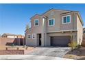Charming two-story home with desert landscaping, brick accents and an attached two-car garage at 2127 Brewer Ave, North Las Vegas, NV 89081