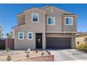 Two-story home featuring desert landscaping, a brick-lined yard, and a two-car garage at 2127 Brewer Ave, North Las Vegas, NV 89081