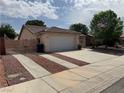 Attractive single story home with a two-car garage, wide driveway, and well maintained landscaping at 228 Hiawatha Way, Mesquite, NV 89027