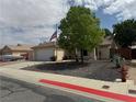 Inviting single story home with mature landscaping, two-car garage, and a spacious driveway at 228 Hiawatha Way, Mesquite, NV 89027