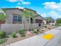 Inviting single-story home with well-designed landscaping featuring desert plants, a rock feature, and hardscape at 253 Robledo St, Las Vegas, NV 89138