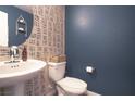 Charming half bath features unique wallpaper and a stylish vessel sink at 2678 Weathered Copper Ave, North Las Vegas, NV 89086