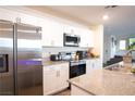 Bright kitchen with granite counters, stainless appliances, and a kitchen sink at 2678 Weathered Copper Ave, North Las Vegas, NV 89086