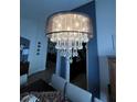 A close up of a beautiful chandelier in the dining room creating an elegant and inviting atmosphere at 2747 Sandalwood Ave, Henderson, NV 89074